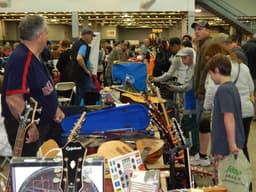 Musical instruments for sale on a vendor table at a past World's Largest Garage Sale event